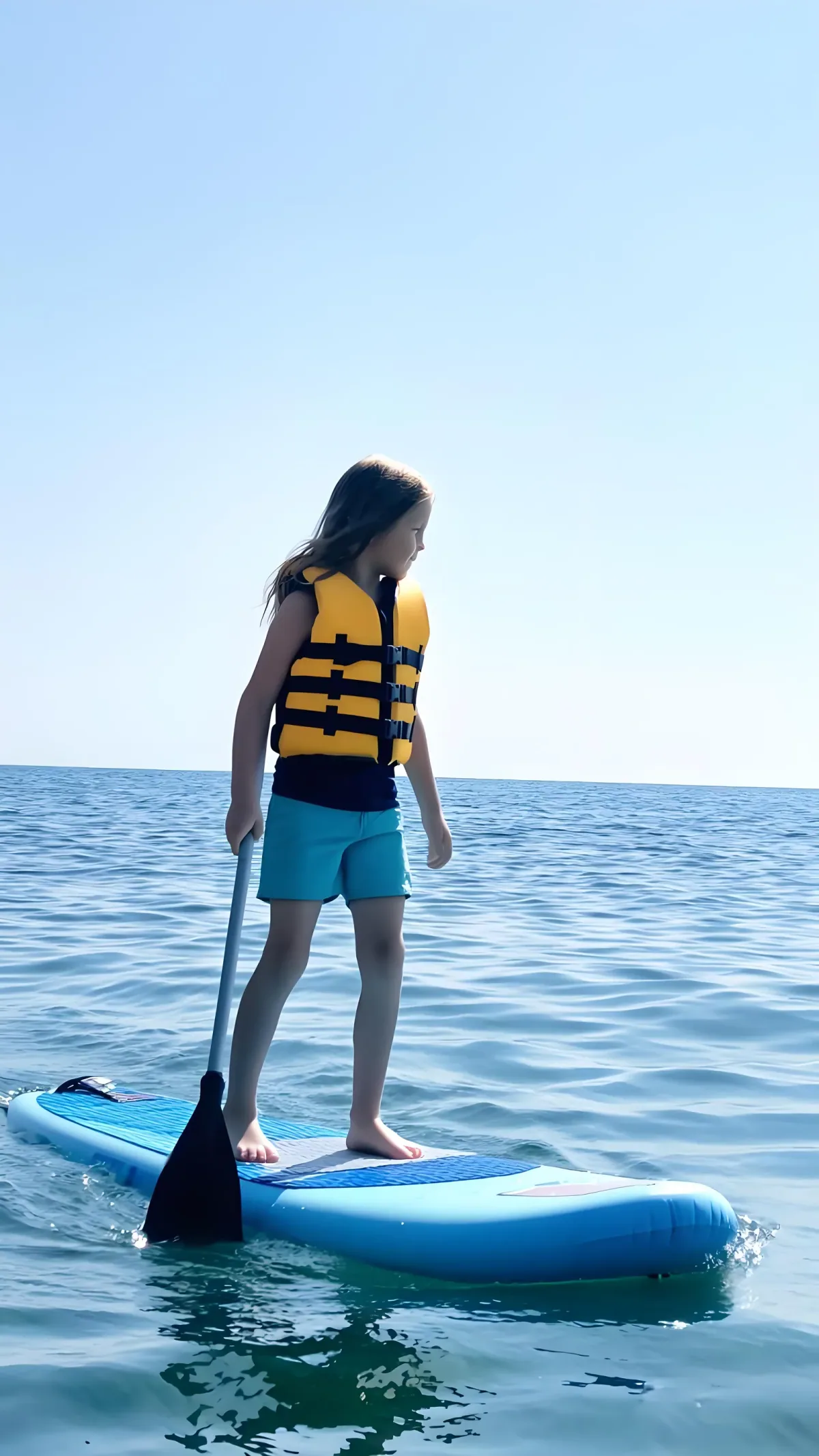 Medusa Glow inflatable SUP paddling on a tropical lagoon